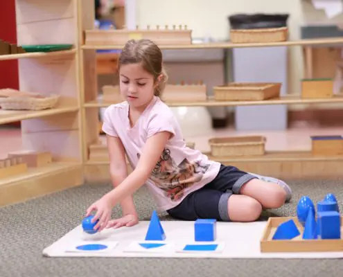 3K4A3367 a group of children exploring Montessori sound boxes to refine auditory senses