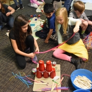 a child practicing writing skills using a Montessori chalkboard